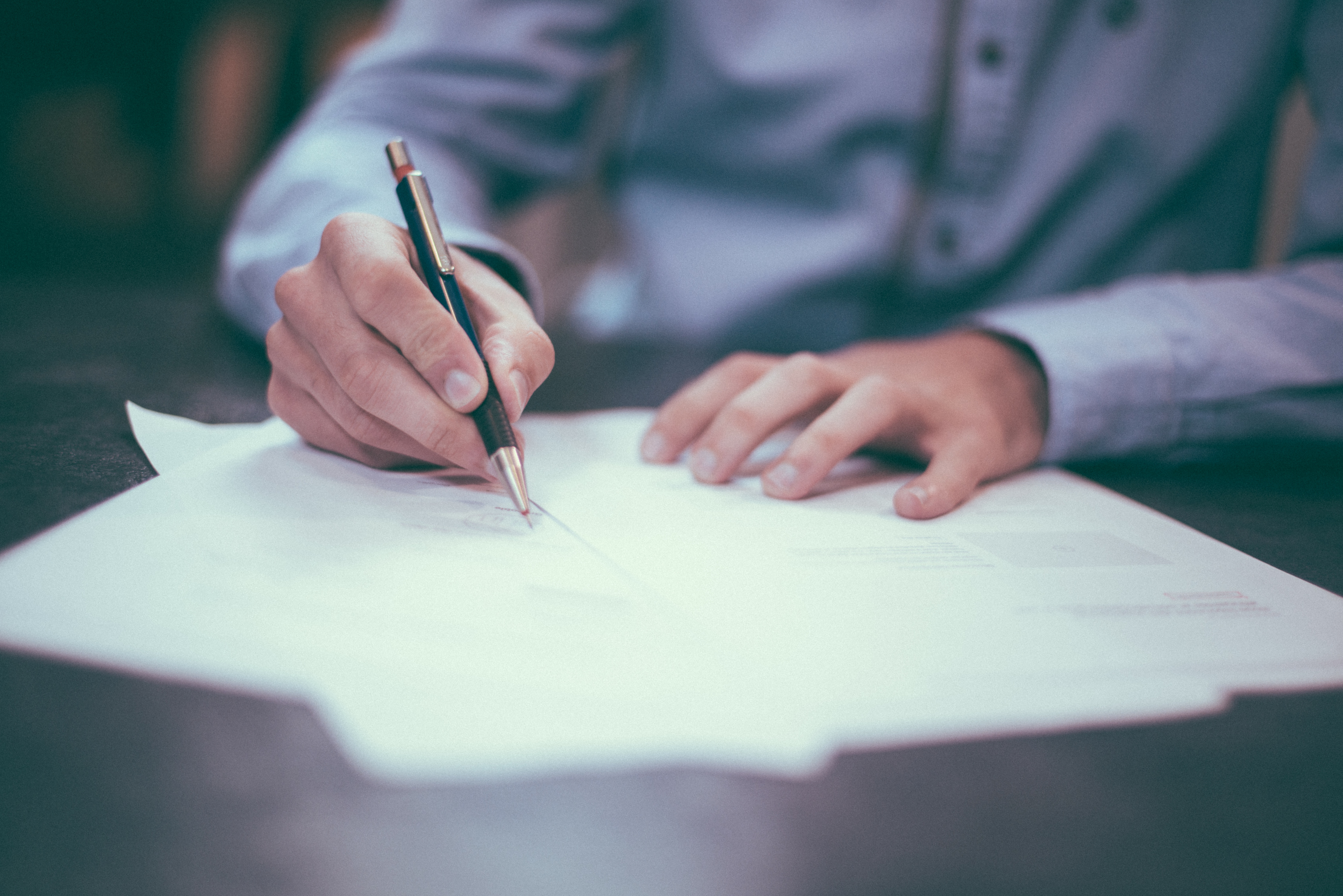 Dakota Electric Association | Electric Rates & Consumer Rights | Man writing on paper
