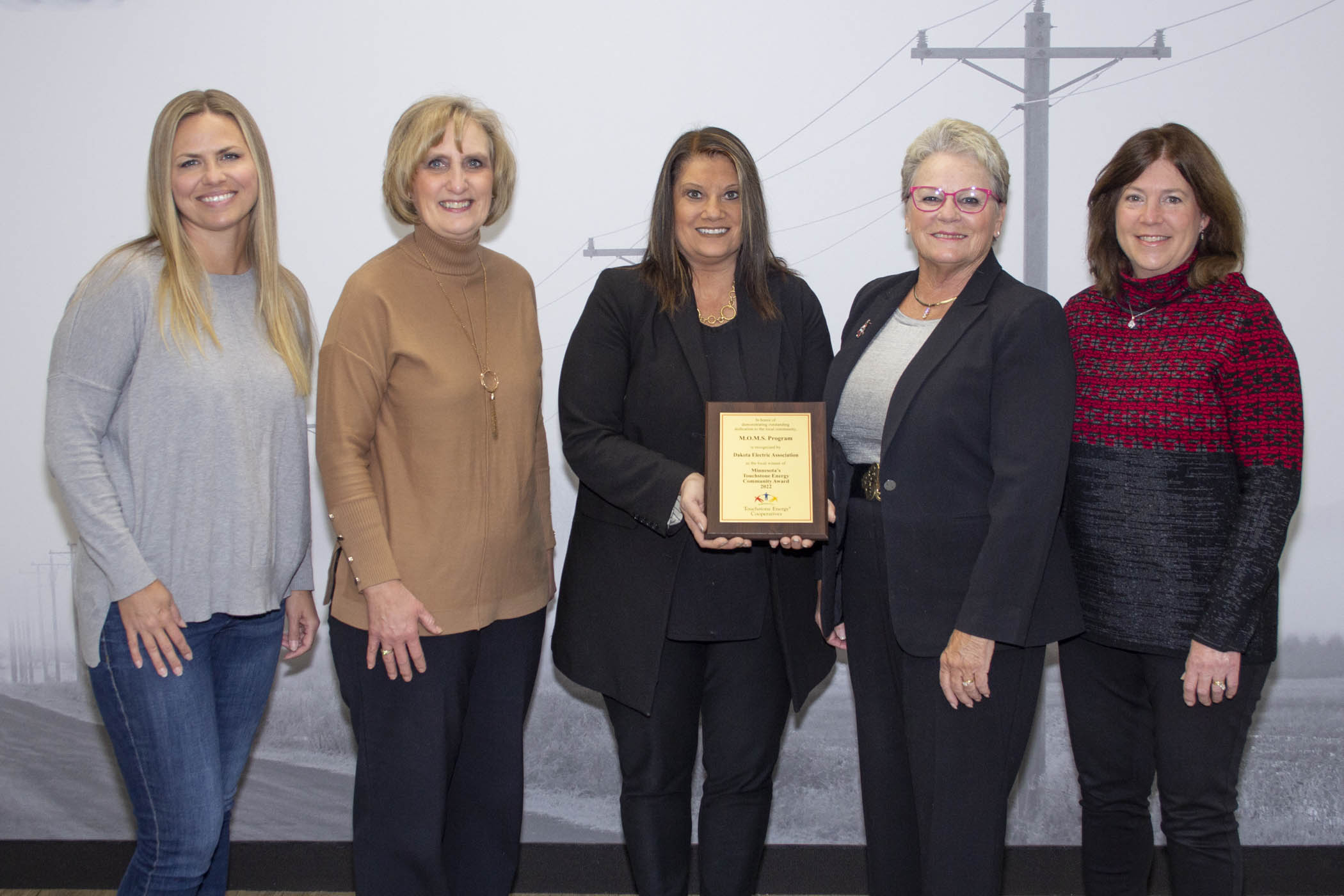 M.O.M.S. five women holding an award